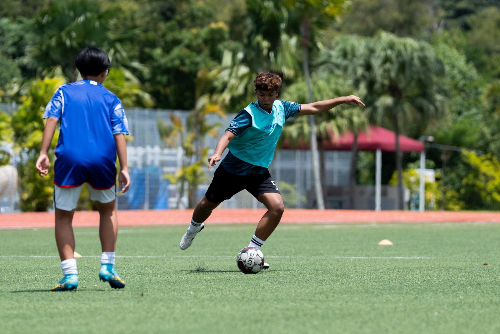 F17 player taking on a defender during a technical training drill