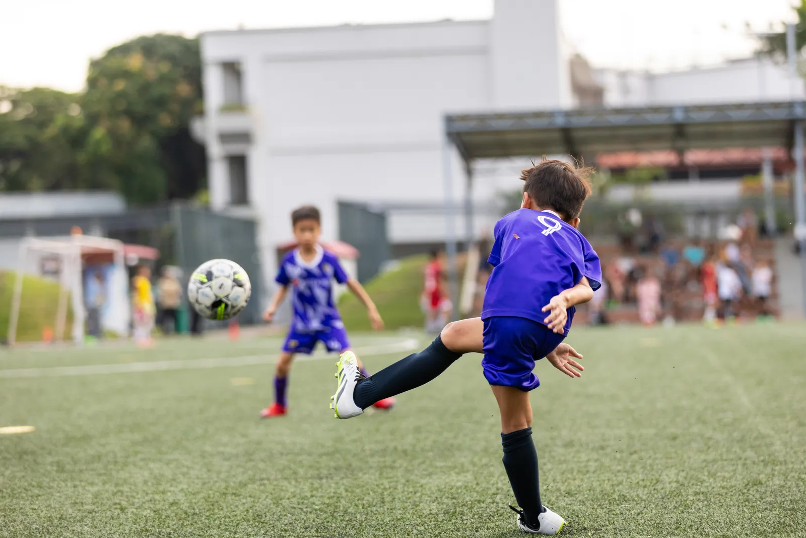F17 U10 player striking the football during a match